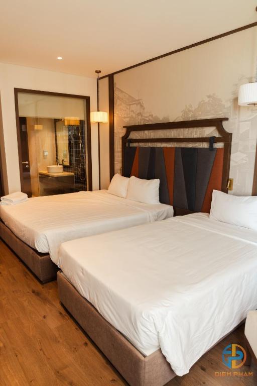 Giường trong phòng chung tại Apec Mandala Cham Bay Mui Ne - Ruby Apartment