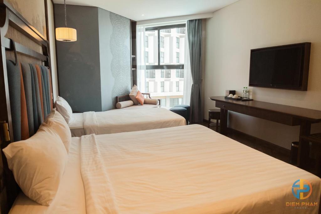 Giường trong phòng chung tại Apec Mandala Cham Bay Mui Ne - Ruby Apartment