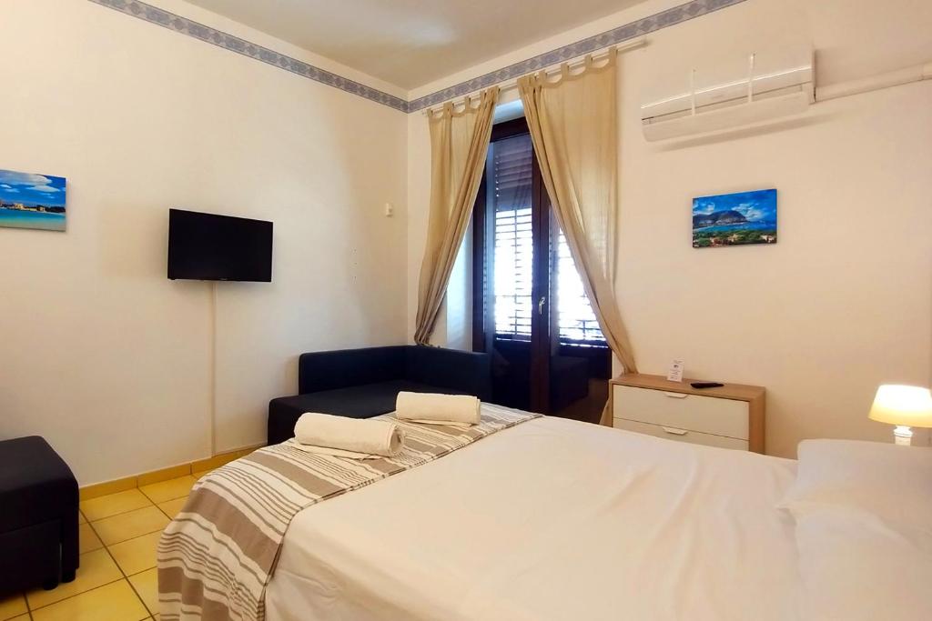 Łóżko lub łóżka w pokoju w obiekcie Porta Carini Residence
