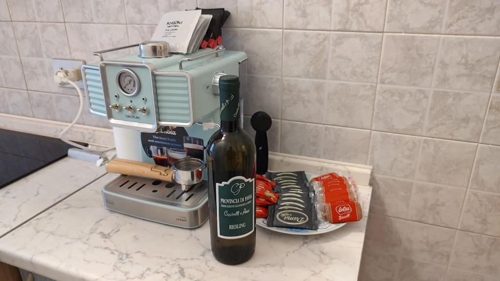 a bottle of wine sitting on a counter next to a blender at Room&Board 2 Bedrooms up to 7 beds 1 Bathroom in Voghera