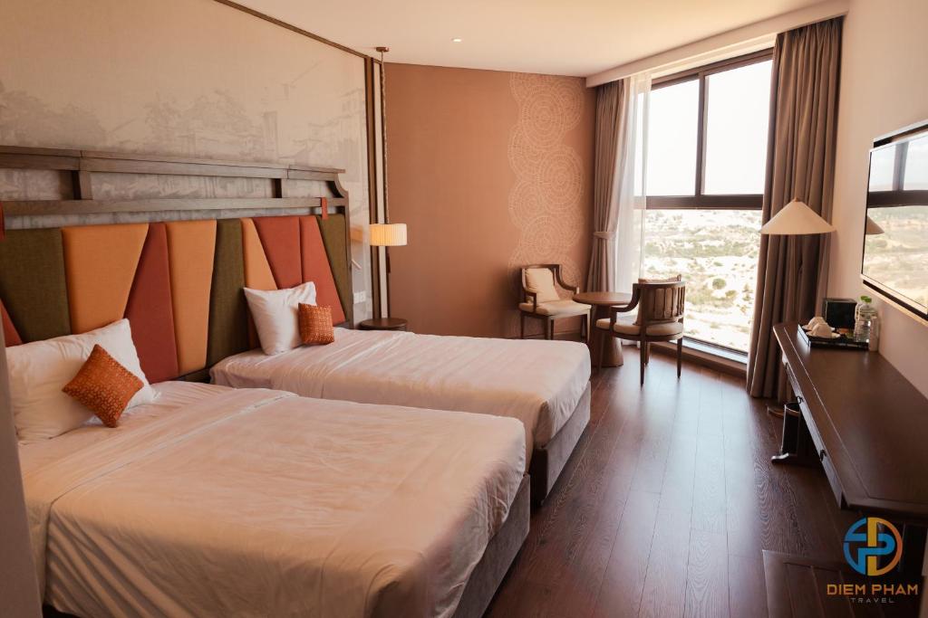 Giường trong phòng chung tại Apec Mandala Cham Bay Mui Ne - Ruby Apartment