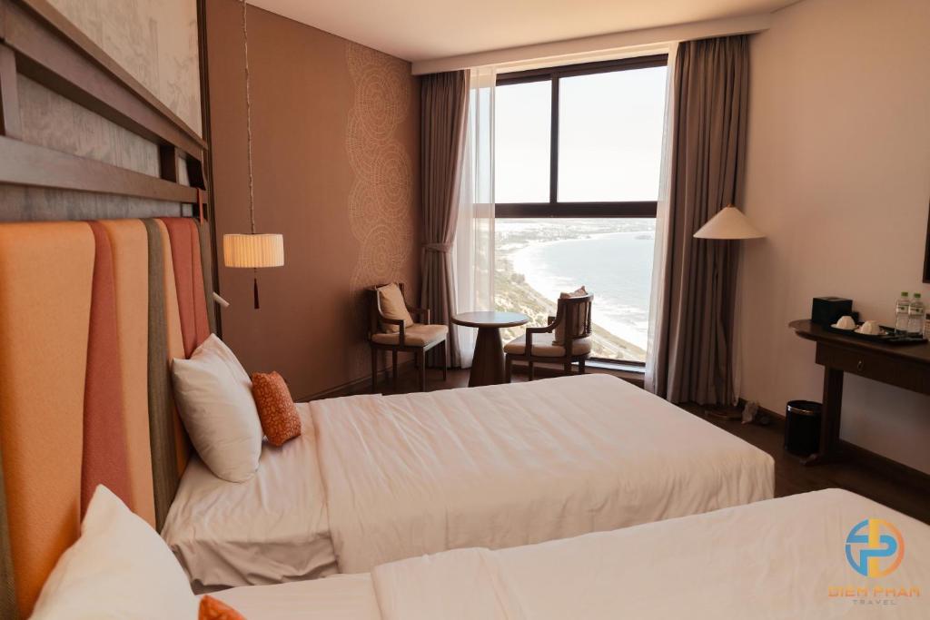 Giường trong phòng chung tại Apec Mandala Cham Bay Mui Ne - Ruby Apartment