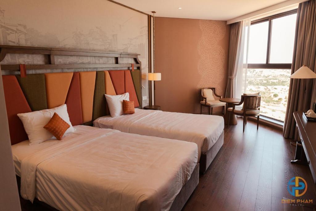 Giường trong phòng chung tại Apec Mandala Cham Bay Mui Ne - Ruby Apartment