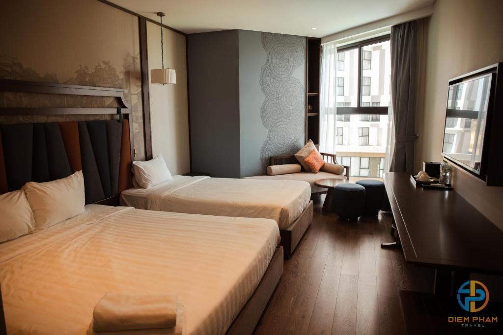 Giường trong phòng chung tại Apec Mandala Cham Bay Mui Ne - Ruby Apartment