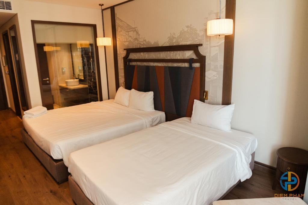 Giường trong phòng chung tại Apec Mandala Cham Bay Mui Ne - Ruby Apartment