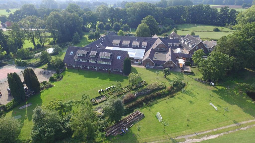 an aerial view of a large house on a green field at Landhuishotel De Bloemenbeek in De Lutte