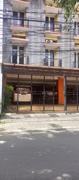 a building with a gate in front of a building at Atmawidjaja house in Jakarta