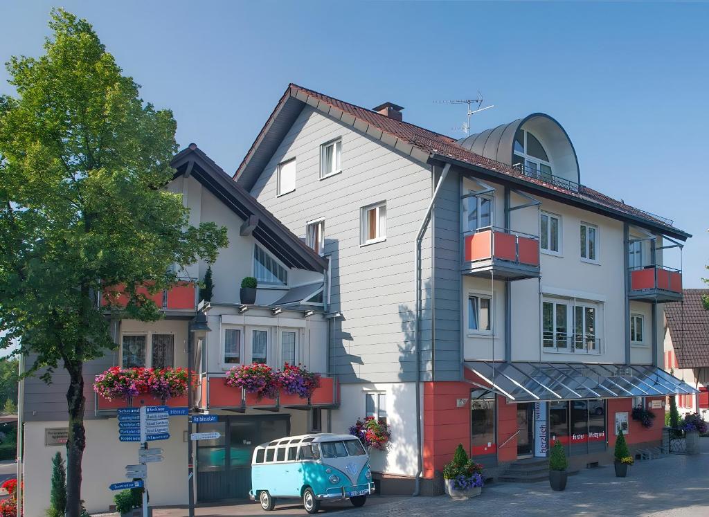 a blue van parked in front of a building at Ferienwohnungen Merkle in Wasserburg am Bodensee