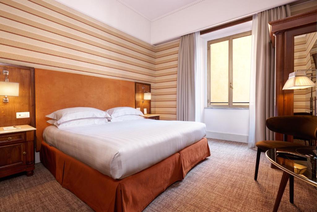 Postel nebo postele na pokoji v ubytování Hotel Mascagni