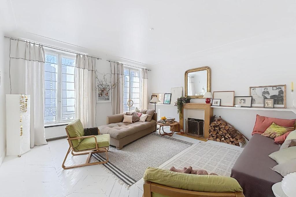 un salon avec un canapé et une chaise dans l'établissement Spacious apartment near Bastille & le Marais, à Paris