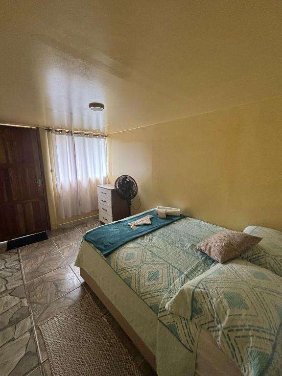 Cama ou camas em um quarto em Pousada & Camping Tubarão