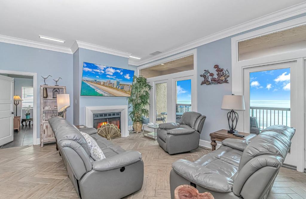 a living room with couches and a fireplace at Penthouse Luxury Oceanfront Condo 3 Bedrooms 3 Bathrooms Ocean Dunes Tower 1 Unit 4155 in Myrtle Beach