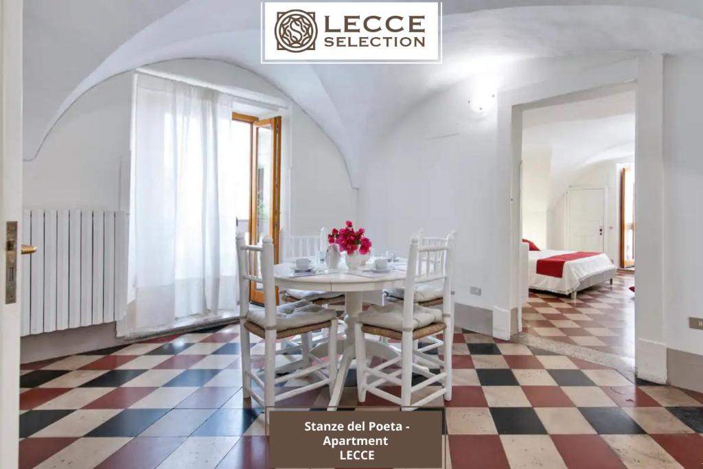 a room with a table and chairs on a checkered floor at Le Stanze del Poeta Apartment - Lecce Selection in Lecce