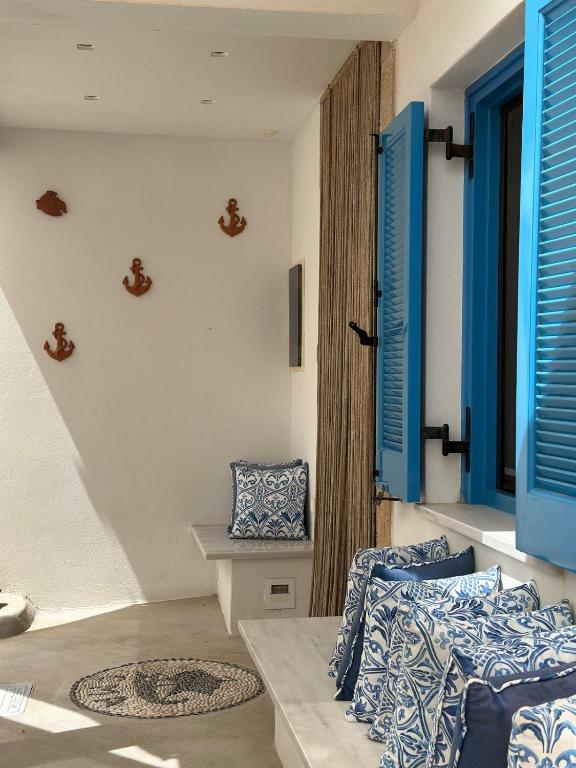 a living room with blue shutters and a couch at Kytheros in Potamós