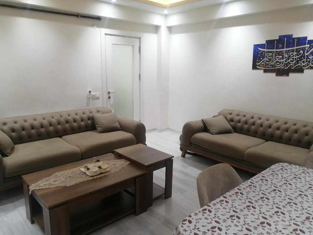 a living room with two couches and a coffee table at Topkapı Centrum in Istanbul