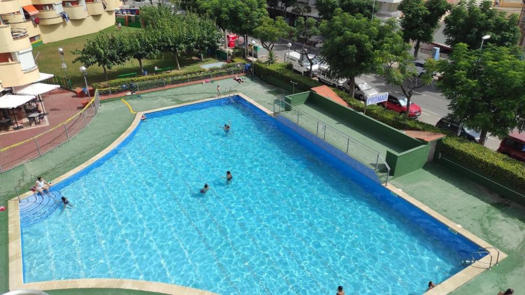 an overhead view of a large swimming pool with people in it at Mediterranean Way - Promar 248 in La Pineda