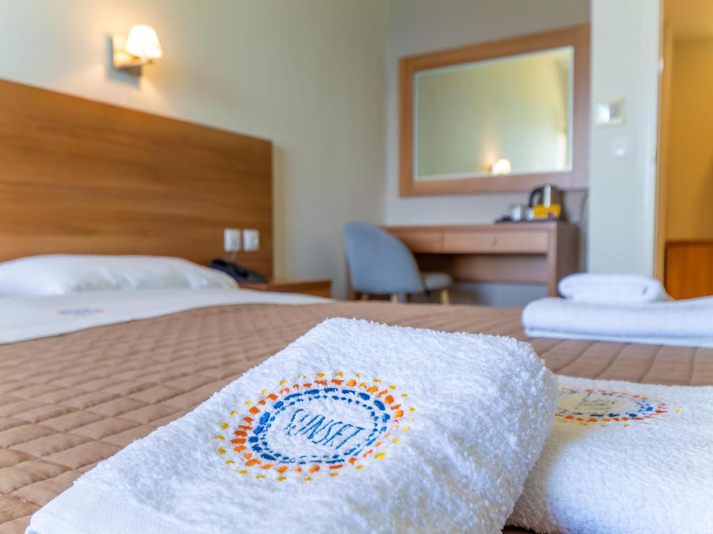 Postel nebo postele na pokoji v ubytování Sunset Hotel