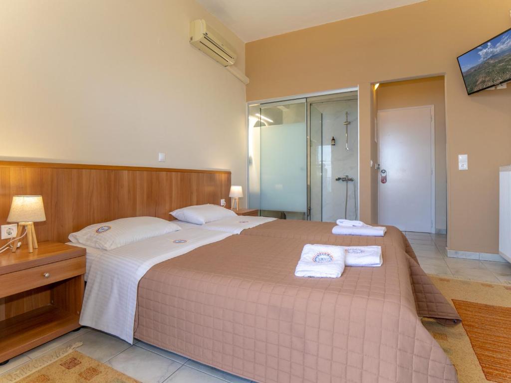 Postel nebo postele na pokoji v ubytování Sunset Hotel