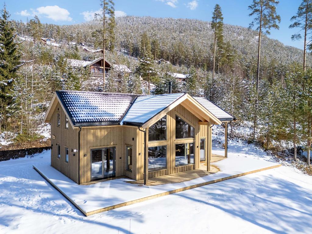 a cabin in the snow in the woods at Lothlórien Lodge | 8p | Sauna in Vradal