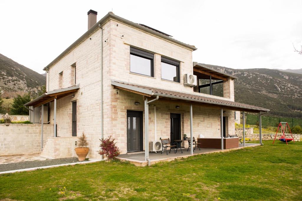 a large house with a lawn in front of it at Villa de Vino in Ioannina