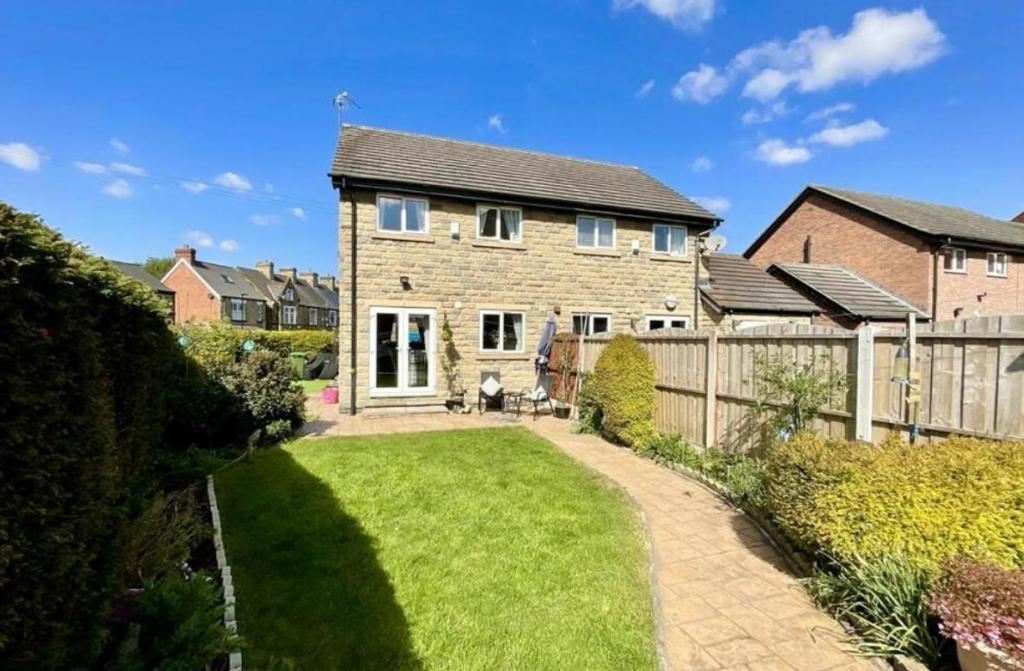 a brick house with a fence and a yard at Cosy Home In Sheffield in Handsworth
