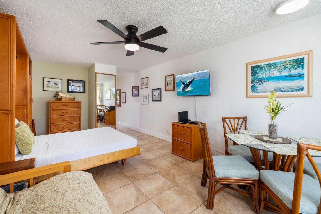 a living room with a bed and a table at Kona Islander Inn#309 in Kailua-Kona