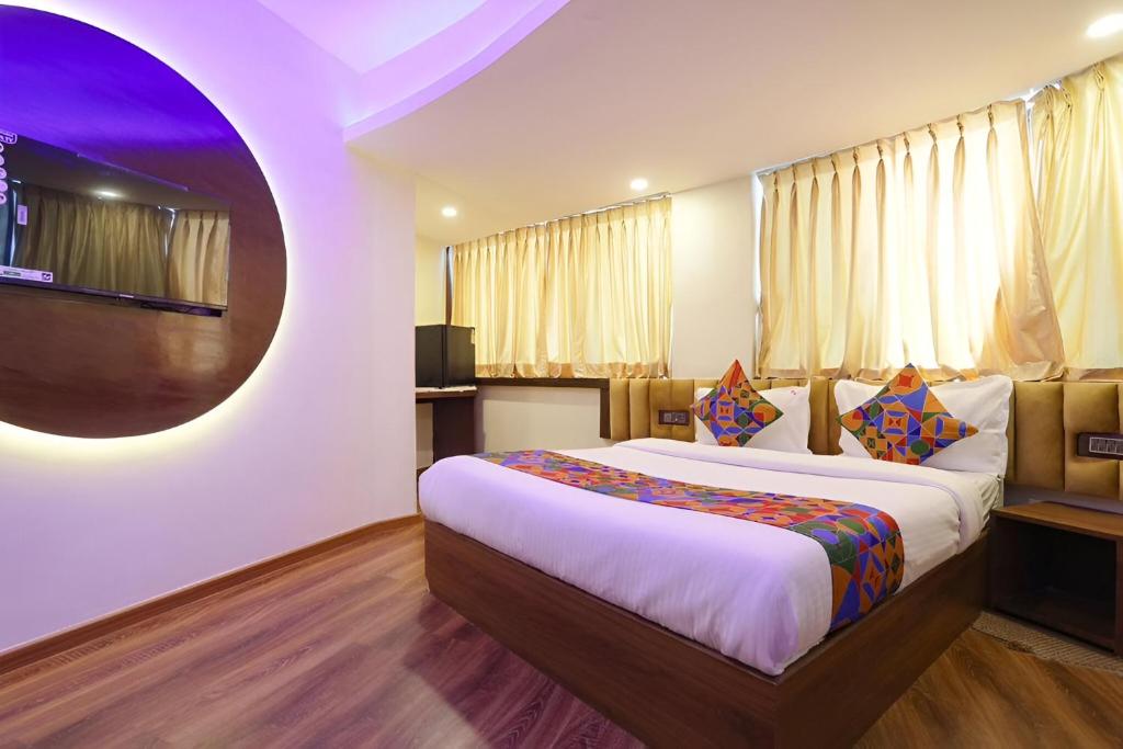 a bedroom with a large bed in a room at Glitz Hotels The Rio - Nr Solitaire Corporate Business Park in Mumbai