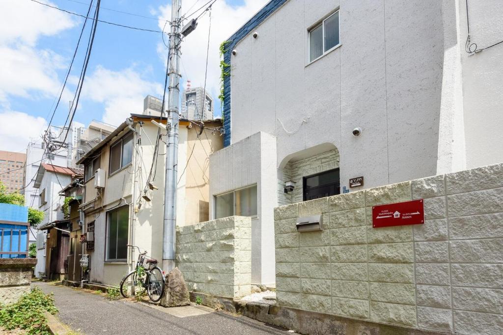 a building on a street with a bike parked next to it at Y's INN NishiShinjuku 018T in Tokyo