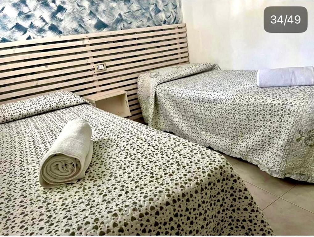 Łóżko lub łóżka w pokoju w obiekcie San Lorenzo Holiday