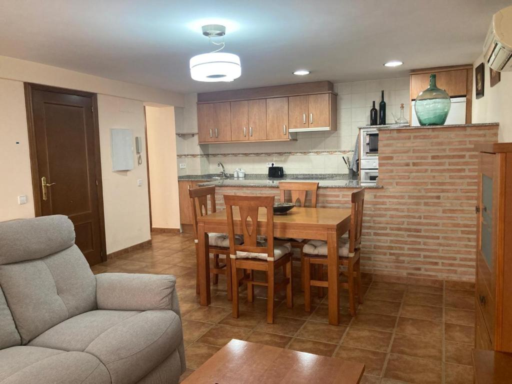 a kitchen and dining room with a table and chairs at Apartamento O'royo in Alquézar