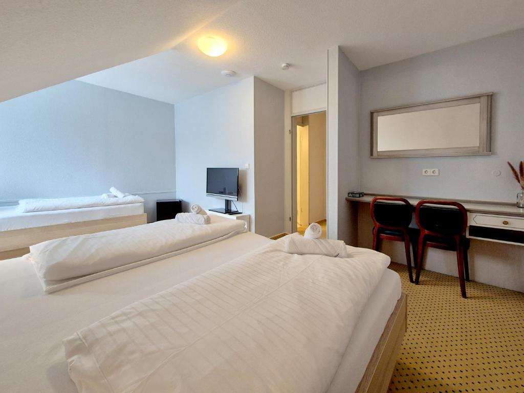 Postel nebo postele na pokoji v ubytování Hotel Schachener Hof