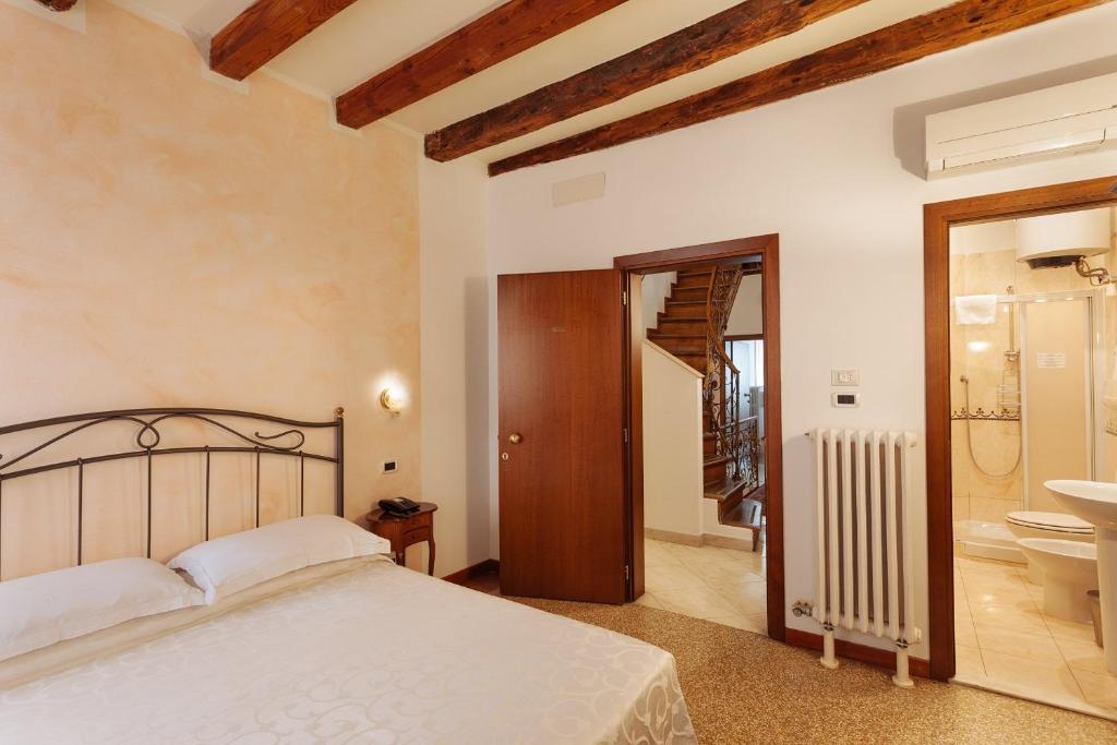 Postel nebo postele na pokoji v ubytování Locanda Art Deco