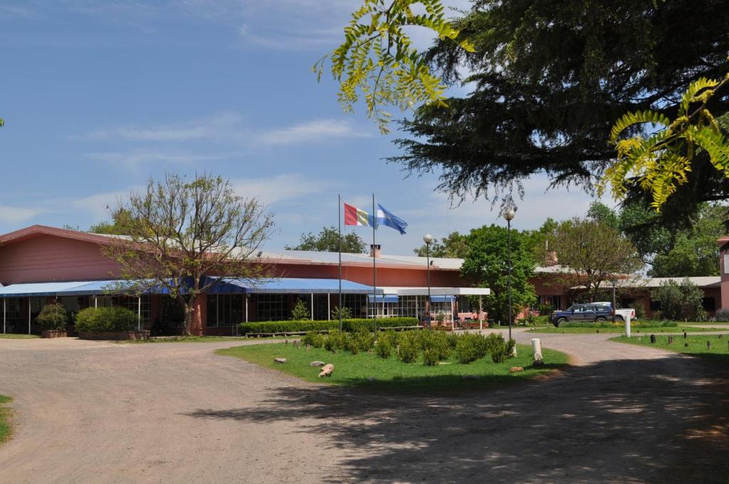 a building with two flags in front of it at Hotel El Molino in Venado Tuerto