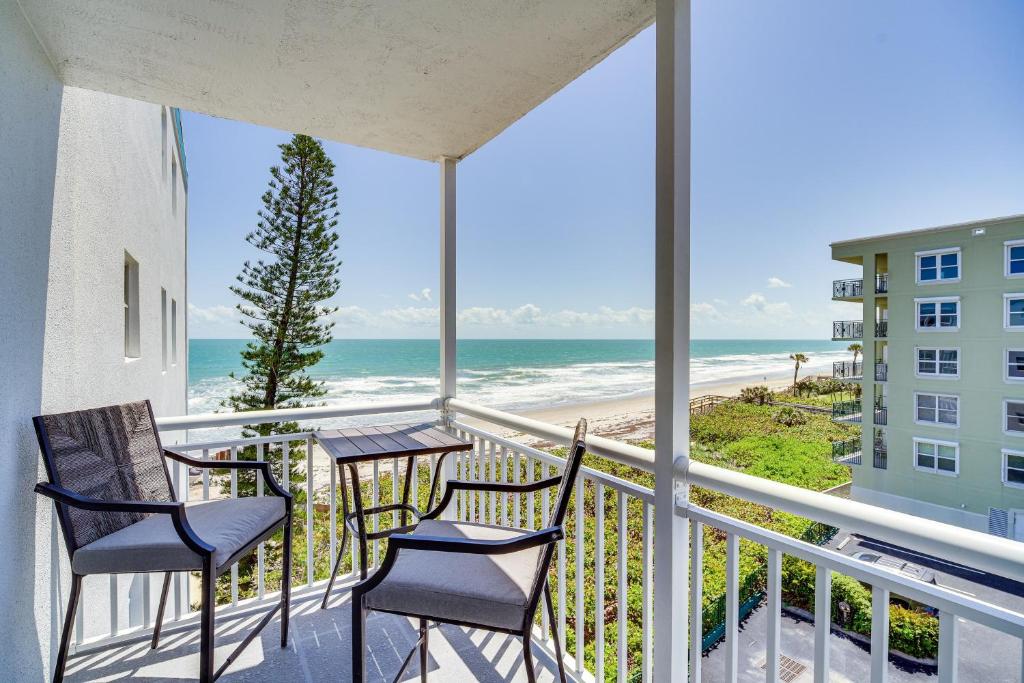 a balcony with chairs and a view of the beach at Oceanview Condo on Satellite Beach! in Satellite Beach