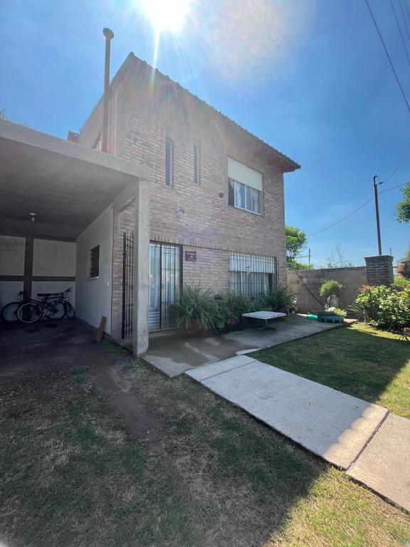 a large brick building with the sun behind it at Casa Lavanda in Embalse