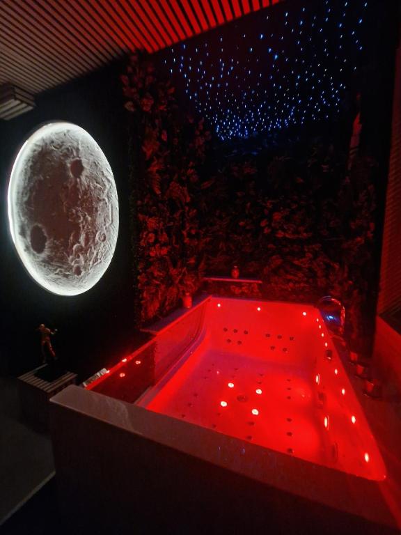 a red bath tub with a moon on the wall at 13Pacate By ElProfesor in Bucharest