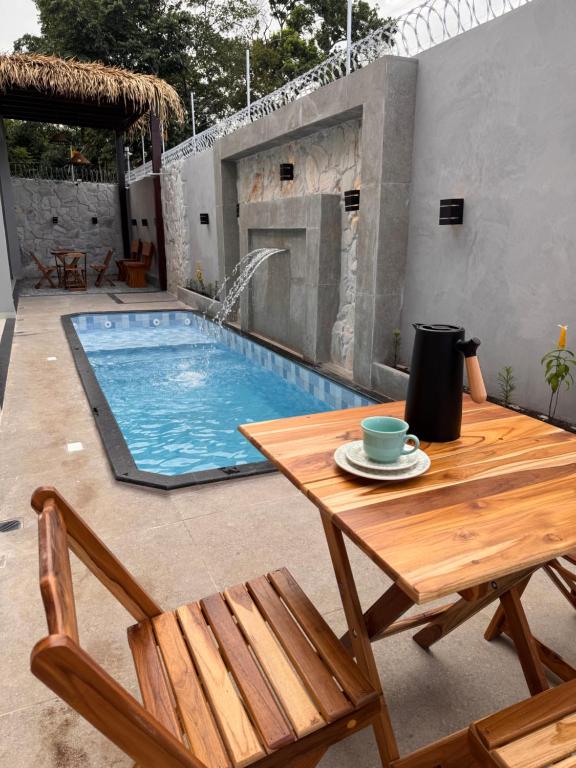 a table and chairs next to a swimming pool at Casa Alter do Sol - 3 suites in Alter do Chao