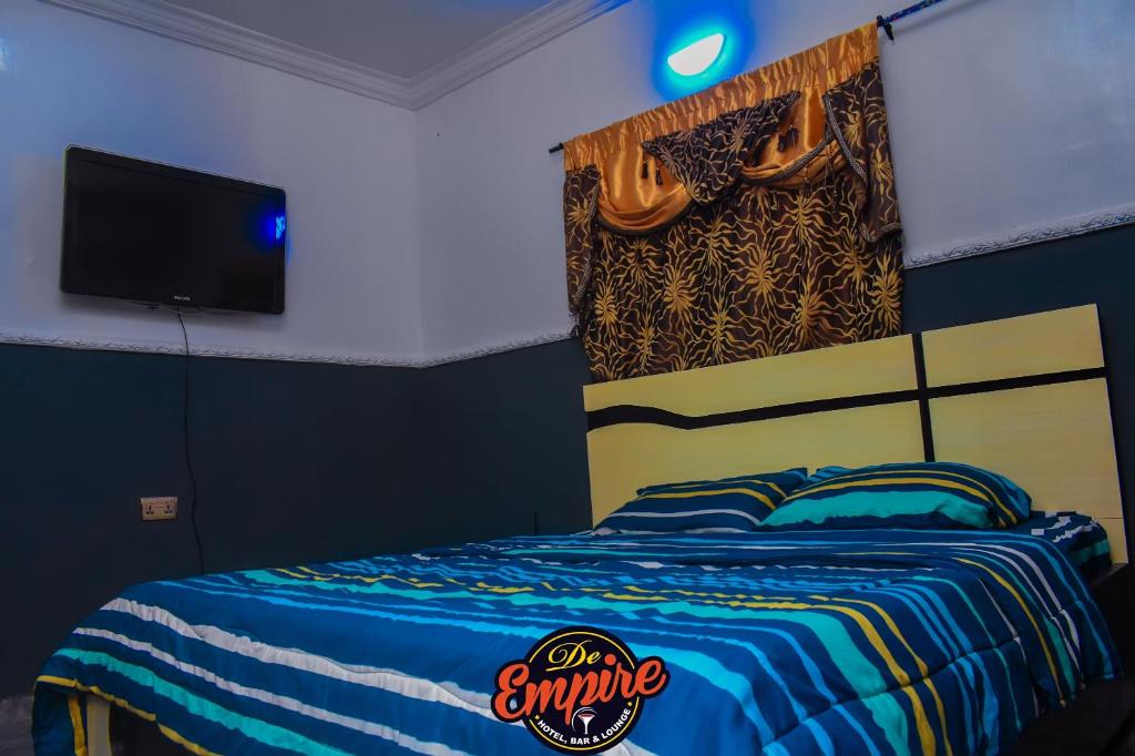 Postel nebo postele na pokoji v ubytování De Empire Hotel