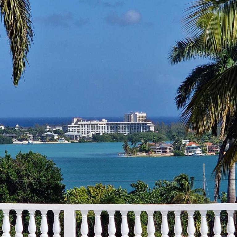 a view of the water with a white fence at Turquoise Sea Villa in Montego Bay