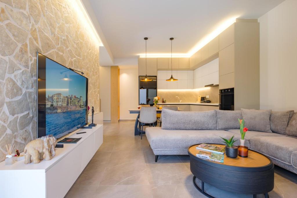 a living room with a couch and a tv at Olive Garden House in Gastourion