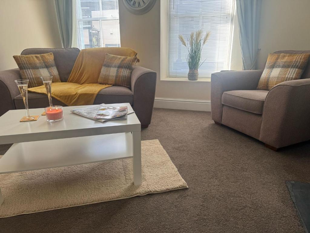 a living room with a couch and a table at The Hidden Hicks - Sleeps 2 in Whitehaven