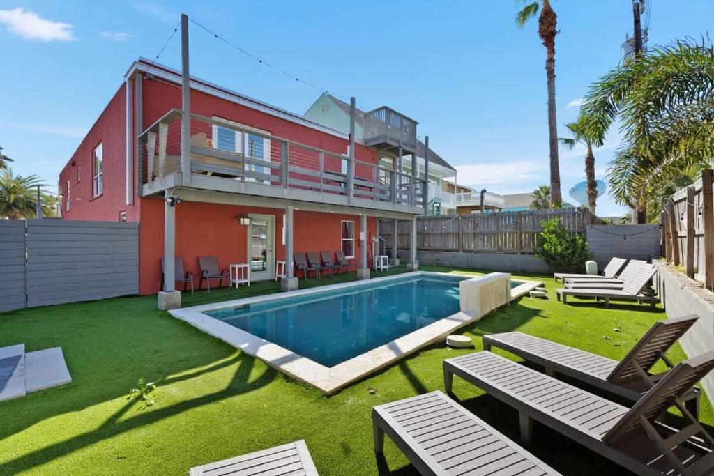 a house with a swimming pool in the yard at Beach Paradise Getaway in South Padre Island in South Padre Island