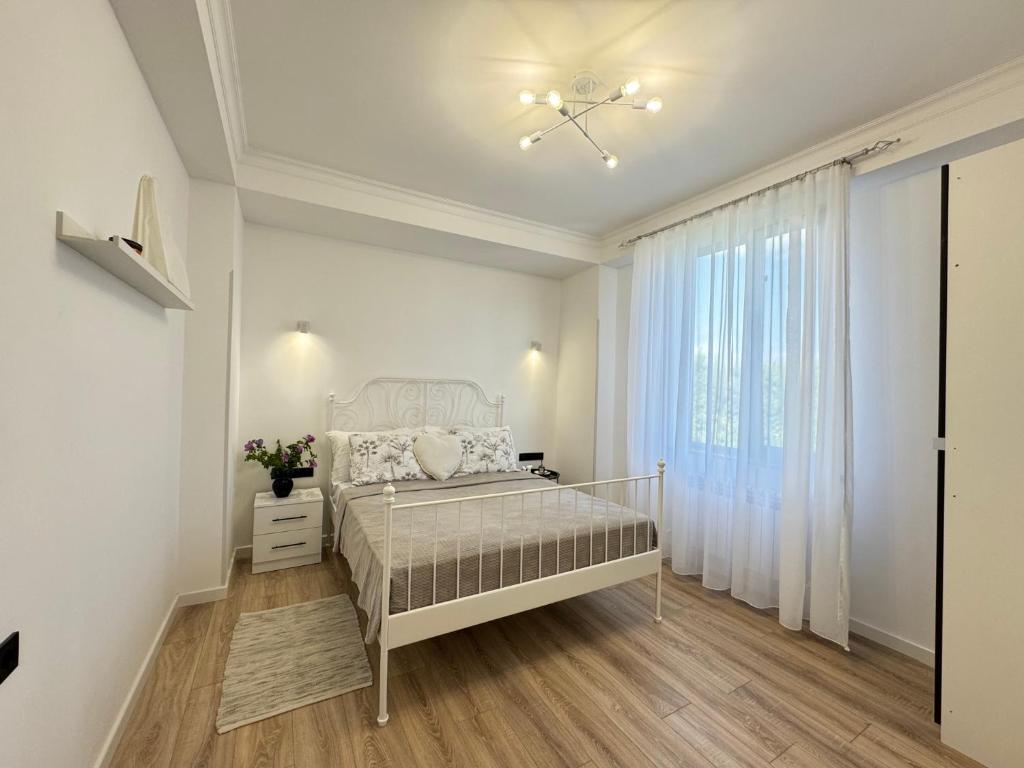a white bedroom with a bed and a window at SamMar B&B in Ashtarak