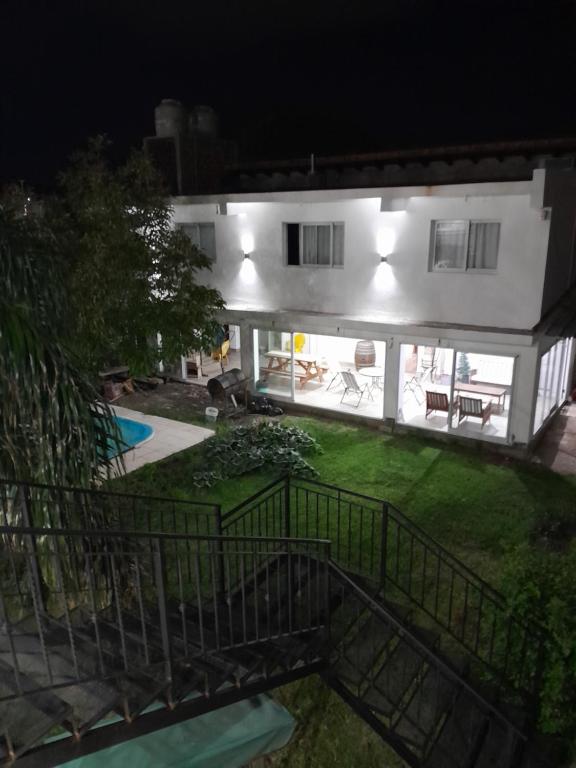 a white house with a courtyard at night at La Chacarita apart in San Fernando del Valle de Catamarca