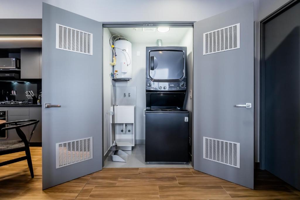 Kuchyň nebo kuchyňský kout v ubytování Centriqo by Wynwood House