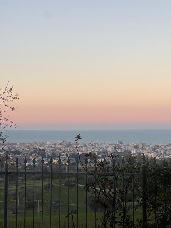 a view of a city from a fence at sunset at La casa di Ernino in Tortoreto Lido