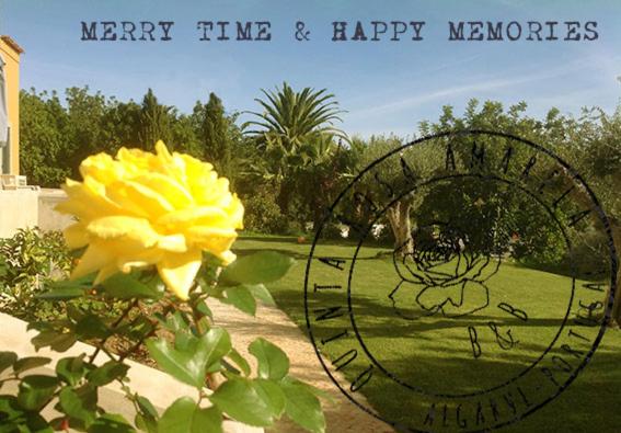 a yellow flower in a park with a happy memories sign at Quinta Rosa Amarela in Boliqueime