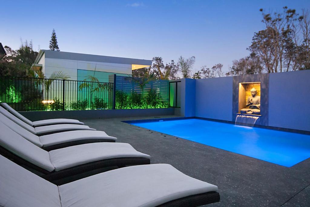 a swimming pool in the backyard of a house at Cavvanbah - April Sun Villa in Byron Bay