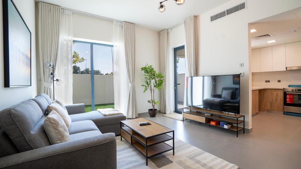 a living room with a couch and a table at 4br Spacious Villa Backyard in Abu Dhabi