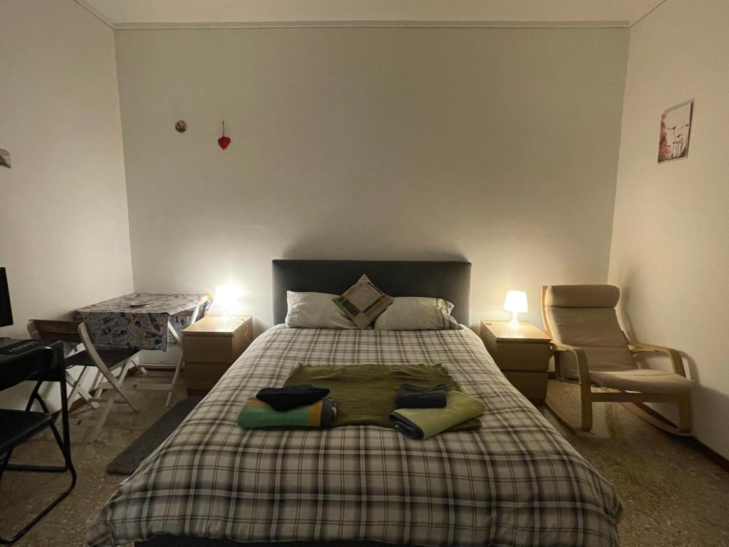 a bedroom with a bed with two chairs and a table at Private and quiet room in Rome